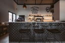The Place Bike Hub, bar counter covered with Betonbrick