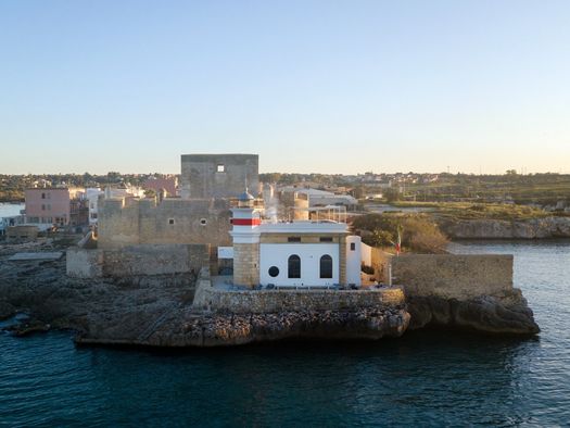 A Refurbished Lighthouse With a View of Mount Etna