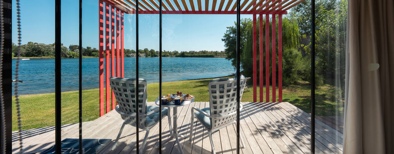 Nomadaria, la casa a bordo lago che abbraccia un albero