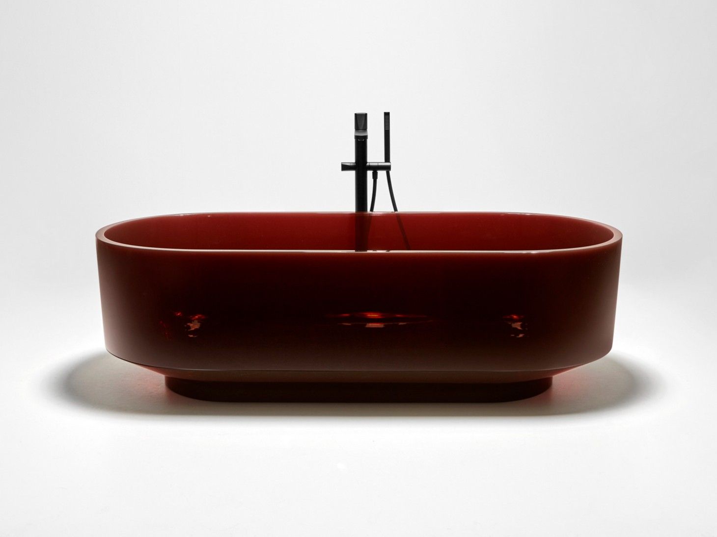 Antonio Lupi Borghi freestanding Cristalmood bathtub — oval form with narrow pedestal base, translucent resin, designed by Gumdesign