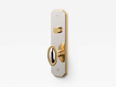 Brass door knob on backplate with lock DUET Lo & Co Interiors